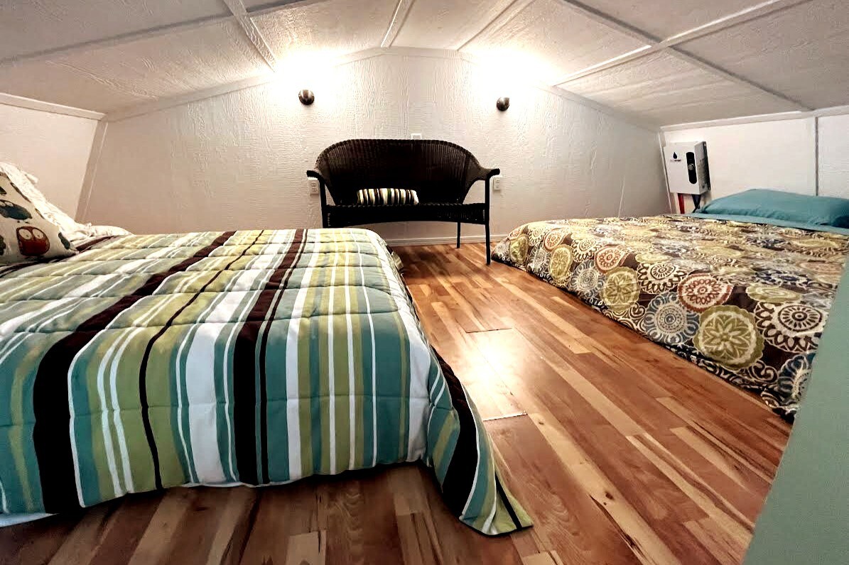 Upstairs loft including seating and one queen and one king bed.